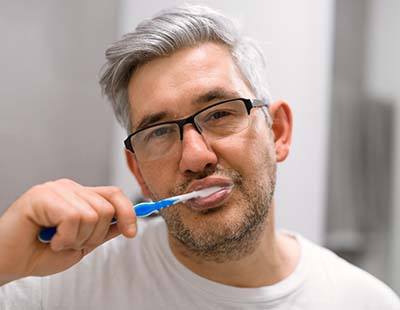 Man brushing teeth to prevent a dental emergency in Frederick
