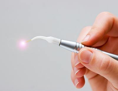 Hand holding a dental laser