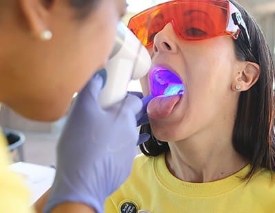 Woman receiving oral cancer screening