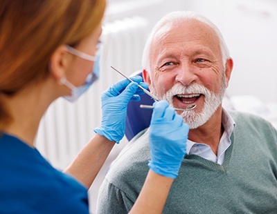 A closeup of a patient receiving a teeth cleaning