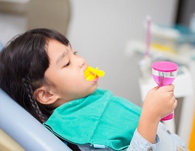 Child receiving fluoride treatment