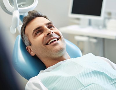 Man lying back in treatment chair and smiling