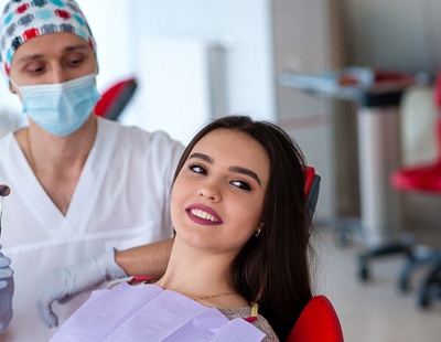 young woman smiling in dental chair