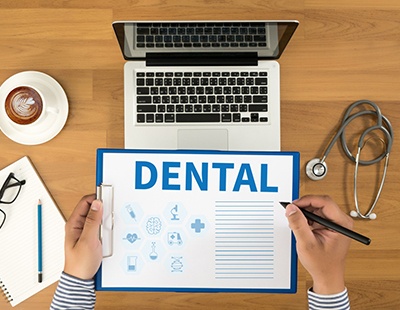 Dental information on blue clipboard