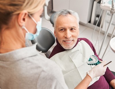 A dentist presenting impressions for dentures 