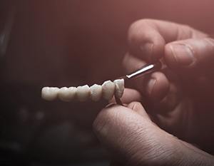 Lab technician painting denture
