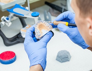 Lab technician working with denture mold