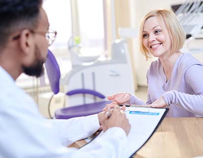 dentist and patient reviewing dental insurance coverage for dental emergencies in Frederick