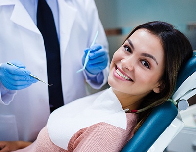 Smiling woman visiting her emergency dentist in Frederick