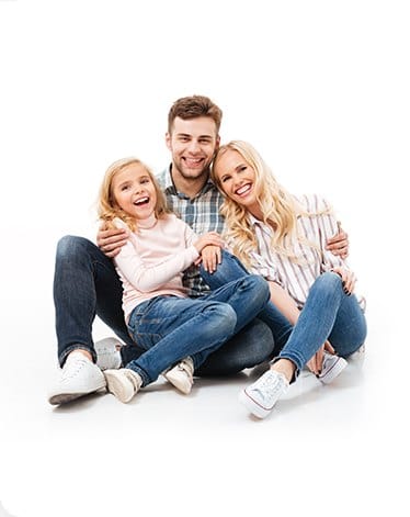 Smiling mother father and daughter sitting on floor