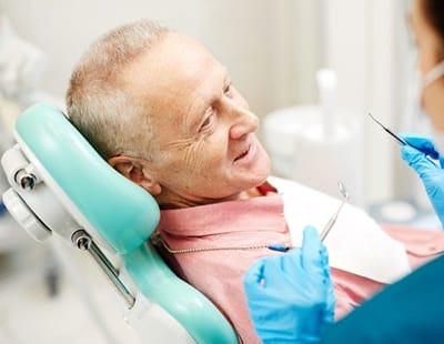 A male patient in the dentist’s chair