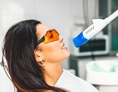 Woman receiving teeth whitening