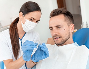 Dentist explaining cost of Invisalign in Frederick to a patient