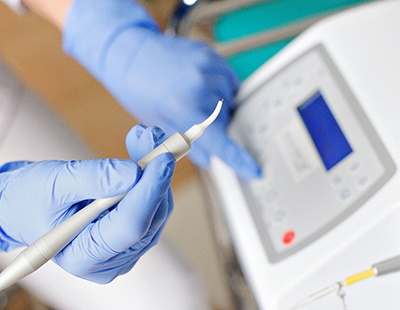 Dental team member preparing to use dental laser