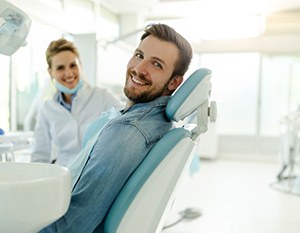 Happy dental patient looking over his shoulder