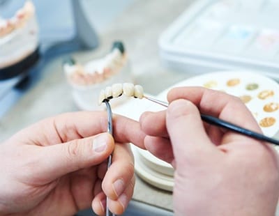 dentist handling prosthesis