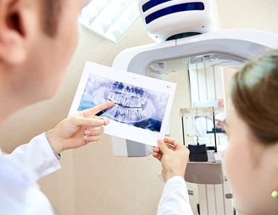 dentist showing patient an X-ray