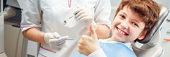 Smiling child in dental chair 