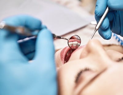dentist inspecting a patient’s mouth