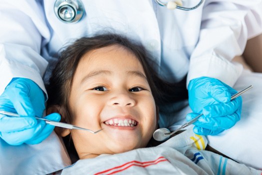 Little girl in dentist’s chair about to undergo exam