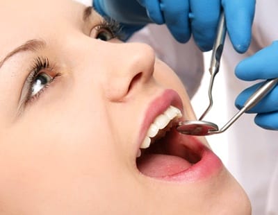 attractive young woman receiving dental exam
