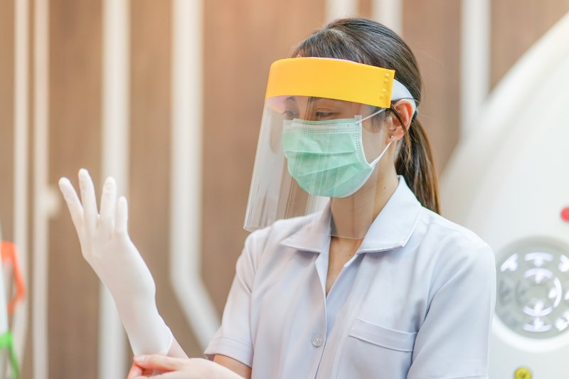 Dentist in Frederick putting on PPE