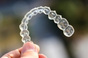 timeline of Invisalign in Frederick aligner on colorful background