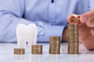 Dentist demonstrating are dental implants in Frederick worth the cost