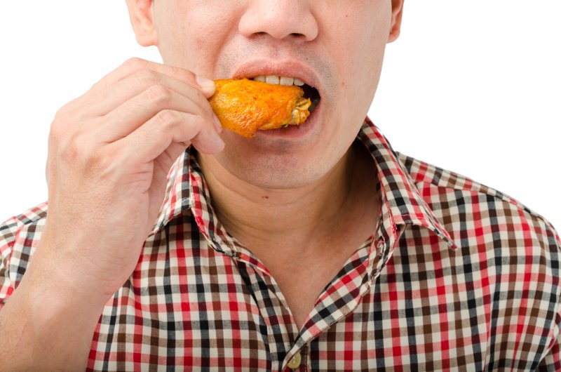 man eating hot wings in Frederick