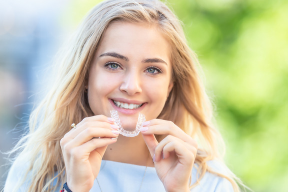 patient smiling while wearing Invisalign