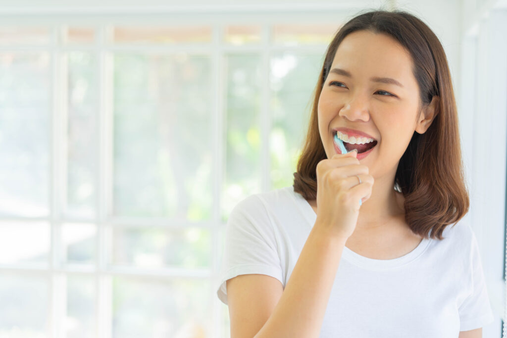 Patient smiling while brushing