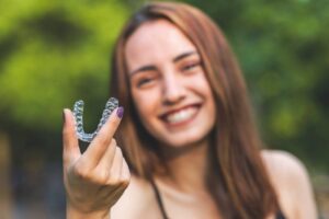 Teen holding up her clear trays